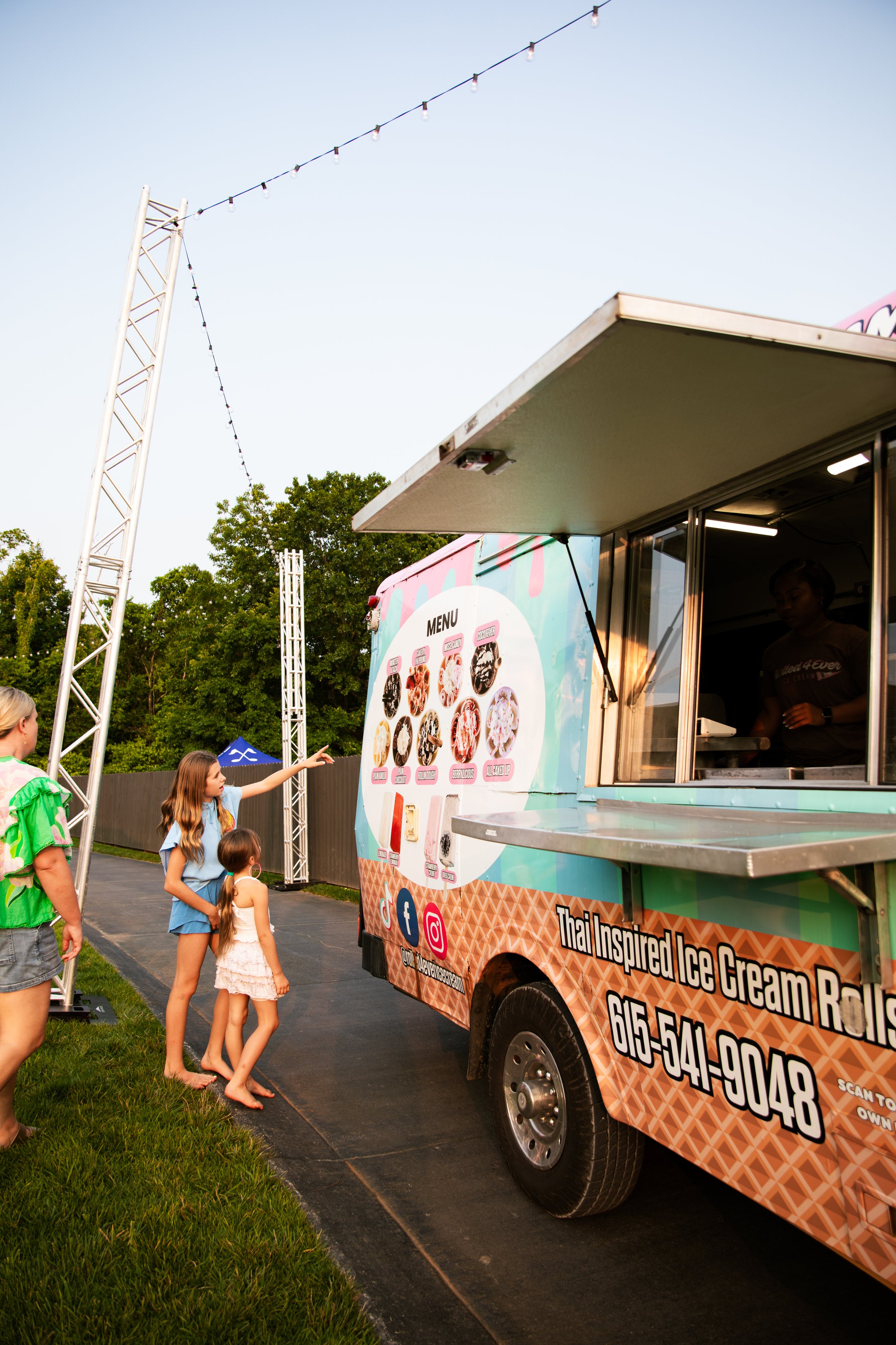 Kids lining up at the Rolled 4 Ever ice cream truck at an evening event
